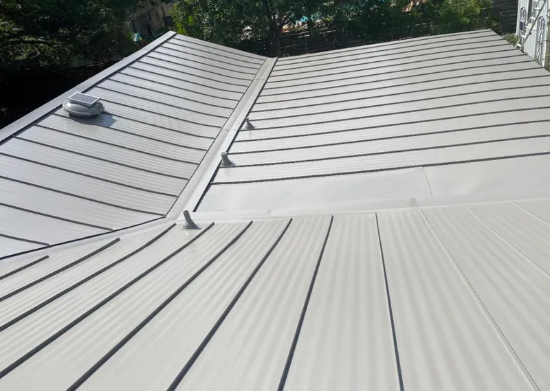 Solar attic fan installed on a metal roof for Roof Ventilation in Borger